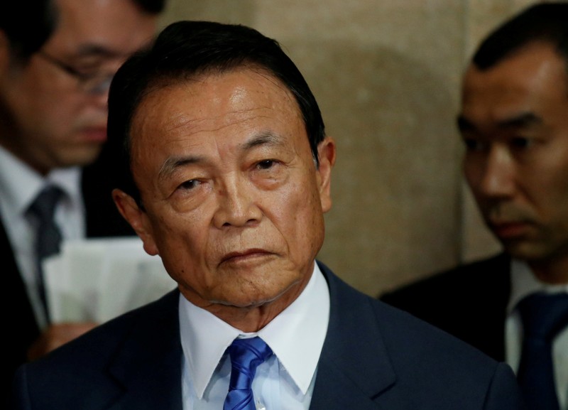 FILE PHOTO - Japan's Deputy Prime Minister and Finance Minister Taro Aso speaks to reporters in Tokyo