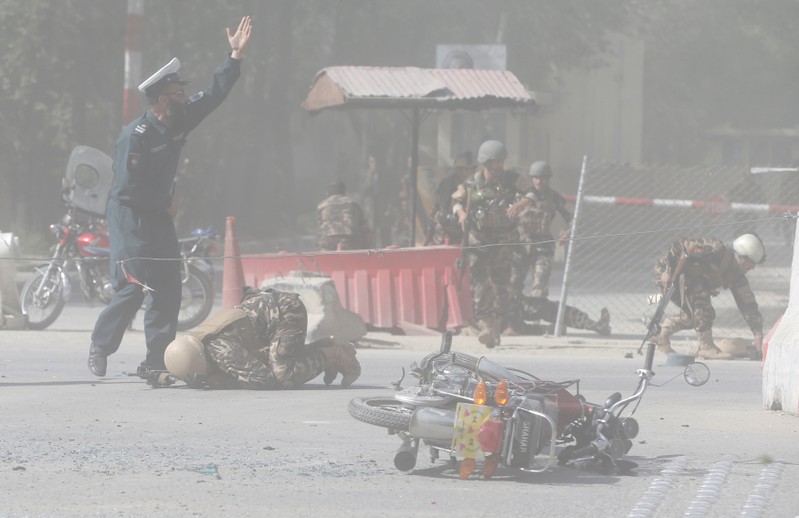 Afghan security forces are seen at the site of a second blast in Kabul, Afghanistan