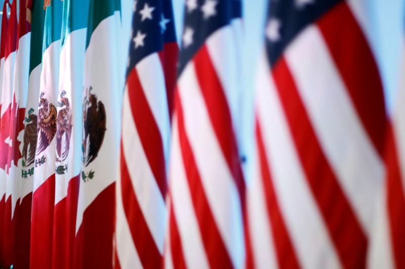 Flags of Canada, Mexico and the U.S. are seen before a joint news conference on the closing of the seventh round of NAFTA talks in Mexico City