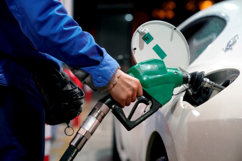 FILE PHOTO: A gas station attendant pumps fuel into a customer's car at a gas station in Shangha