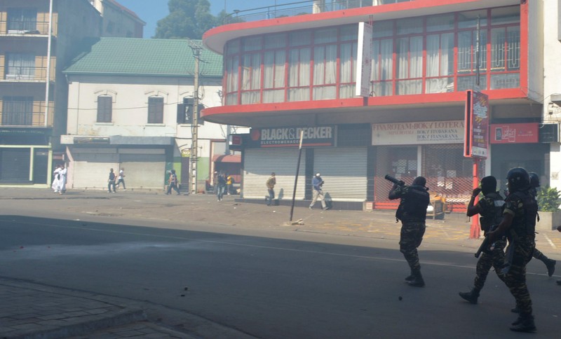 Riot police fire tear gas canisters disperse opposition demonstrators protesting against new electoral laws in Antananarivo