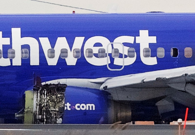 Emergency personnel monitor the damaged engine of Southwest Airlines Flight 1380, which diverted to the Philadelphia International Airport this morning, in Philadelphia, Pennsylvania