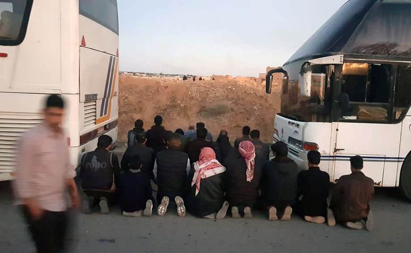 Rebels pray before they are evacuated from the town of Douma, eastern Ghouta, in Damascus