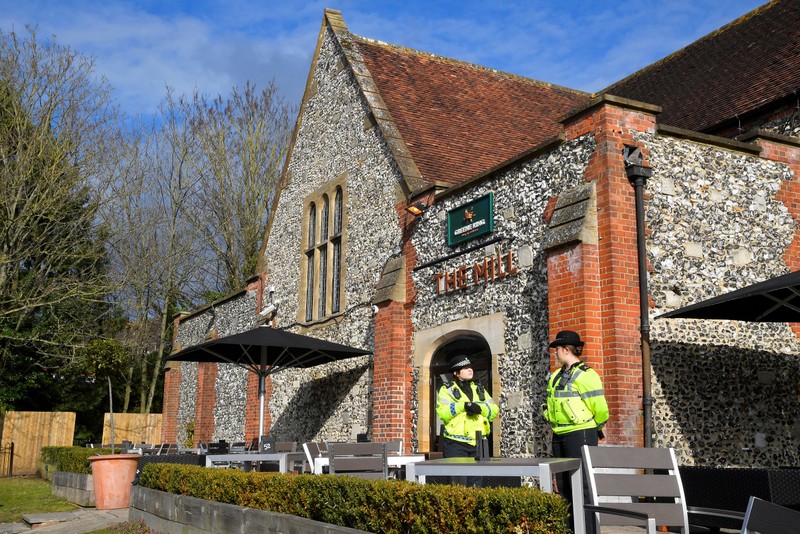 Police officers stand outside a pub near to where former Russian inteligence officer Sergei Skripal, and his daughter Yulia were found unconscious after they had been exposed to an unknown substance, in Salisbury