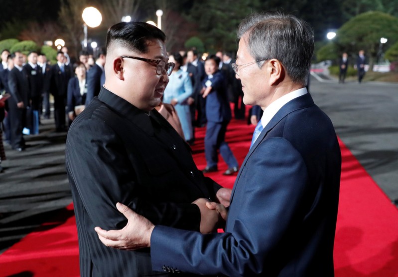 South Korean President Moon Jae-in shakes hands with North Korean leader Kim Jong Un as Kim leaves after a farewell ceremony at the truce village of Panmunjom