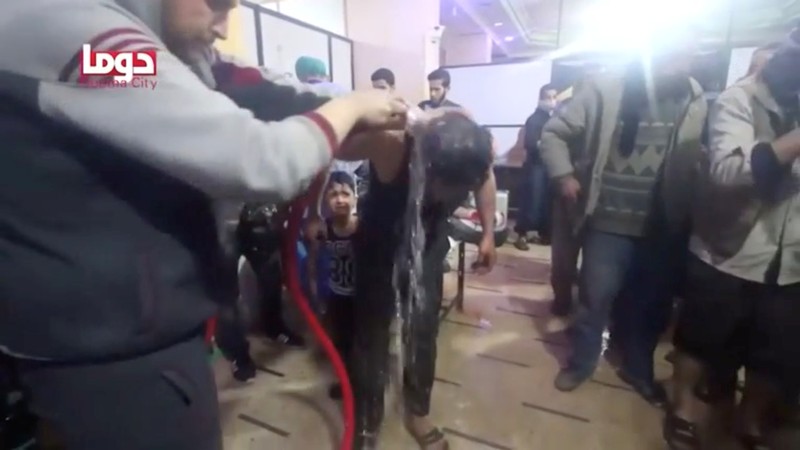 A man is washed following alleged chemical weapons attack, in what is said to be Douma
