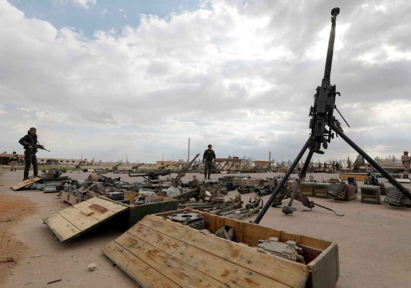 FILE PHOTO: Syrian Army soldiers stand near weapons that belonged to rebels in Dumayr
