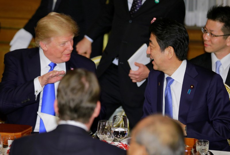 U.S. President Donald Trump talks with Japanese Prime Minister Shinzo Abe at the opening of a welcome dinner hosted by Abe at Akasaka Palace in Tokyo