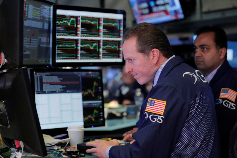 Traders react as they work on the floor of the New York Stock Exchange shortly after the opening bell in New York