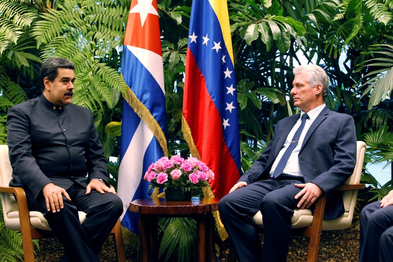 Cuban President Miguel Diaz-Canel speaks to Venezuela's President Nicolas Maduro at the Revolution Palace in Havana