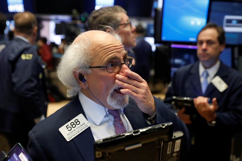 Traders react as they work on the floor of the New York Stock Exchange shortly after the opening bell in New York