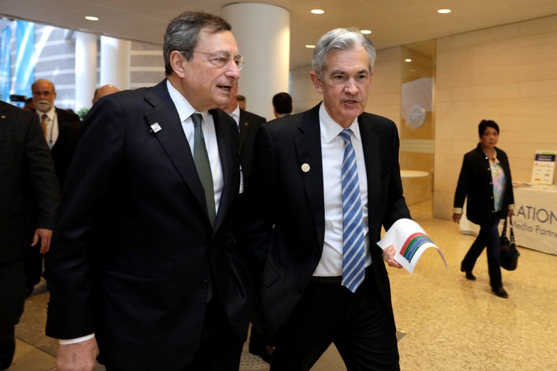 European Central Bank (ECB) President Mario Draghi (L) and Federal Reserve Chairman Jerome Powell walk