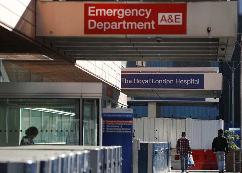 People walk away from the emergency department of the Royal London Hospital, in London