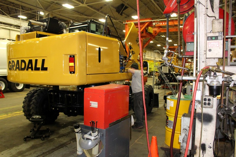 Employee torques hydraulic fittings on XL4300V Wheeled Excavator in New Philadelphia, Ohio