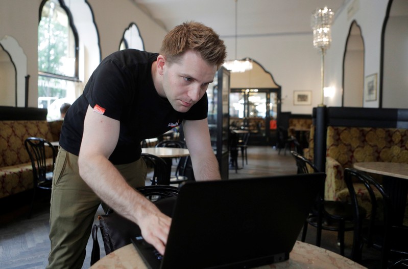 Austrian lawyer and privacy activist Schrems prepares his laptop during a Reuters interview in Vienna
