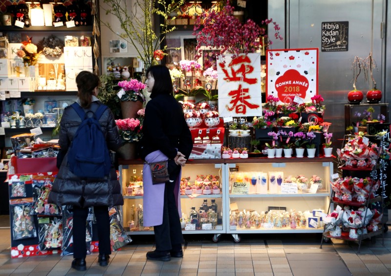 A clerk talks to a customer at a flower shop at a shopping mall in Tokyo