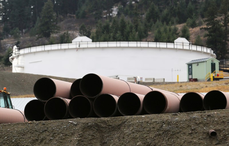 FILE PHOTO: Replacement pipe is stored near crude oil storage tanks at Kinder Morgan's Trans Mountain Pipeline terminal in Kamloops