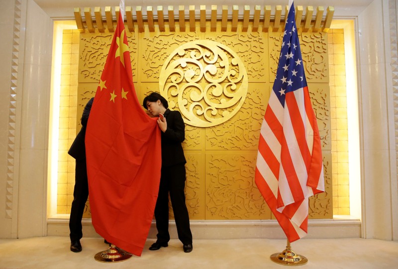 Staff members set up Chinese and U.S. flags for a meeting between Chinese Transport Minister Li Xiaopeng and U.S. Secretary of Transportation Elaine Chao in Beijing