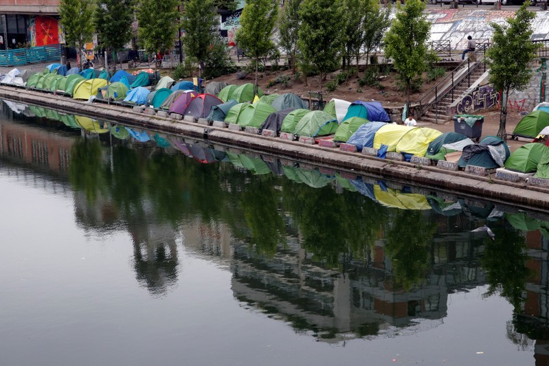 Tents where migrants live are seen on the Quai de Valmy of the canal Saint-Martin in Paris