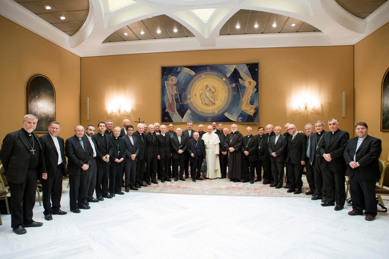 Pope Francis poses with Chilean bishops after a meeting at the Vatican