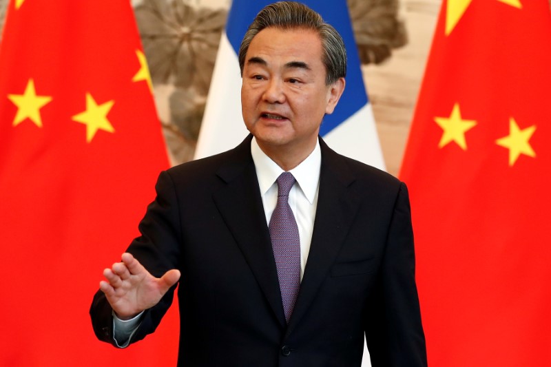 FILE PHOTO - China's State Councilor and Foreign Minister Wang Yi gestures during a signing ceremony in Beijing, China