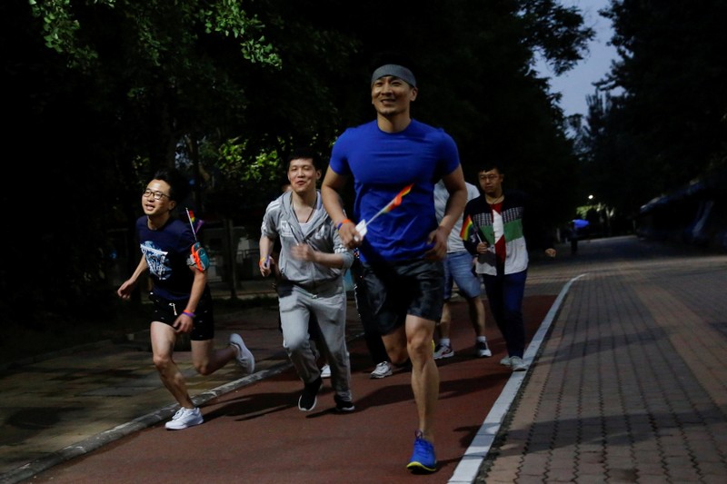 People take part in a 5.17 km run to mark International Day Against Homophobia in a park in Beijing