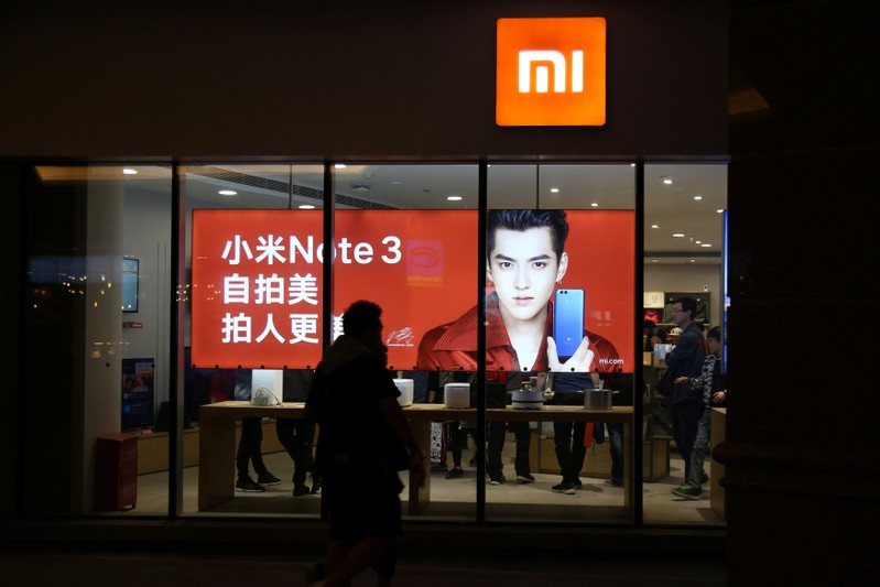 People walk past a Xiaomi store in Beijing