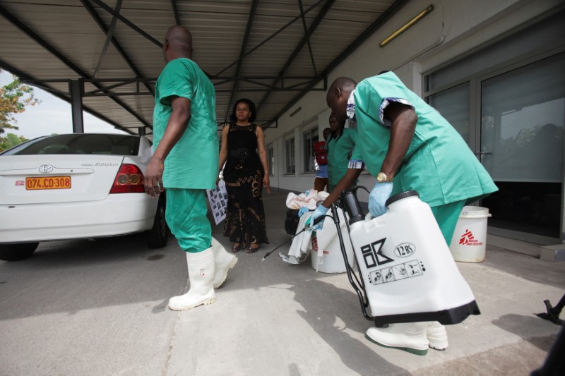 FILE PHOTO: A health worker sprays a colleague with disinfectant during a training session for Congolese health workers to deal with Ebola virus in Kinshasa