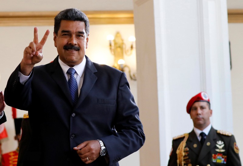 FILE PHOTO: Venezuela's President Nicolas Maduro smiles to the media after a meeting with former Spanish Prime Minister Jose Luis Rodriguez Zapatero at the presidential palace in Caracas