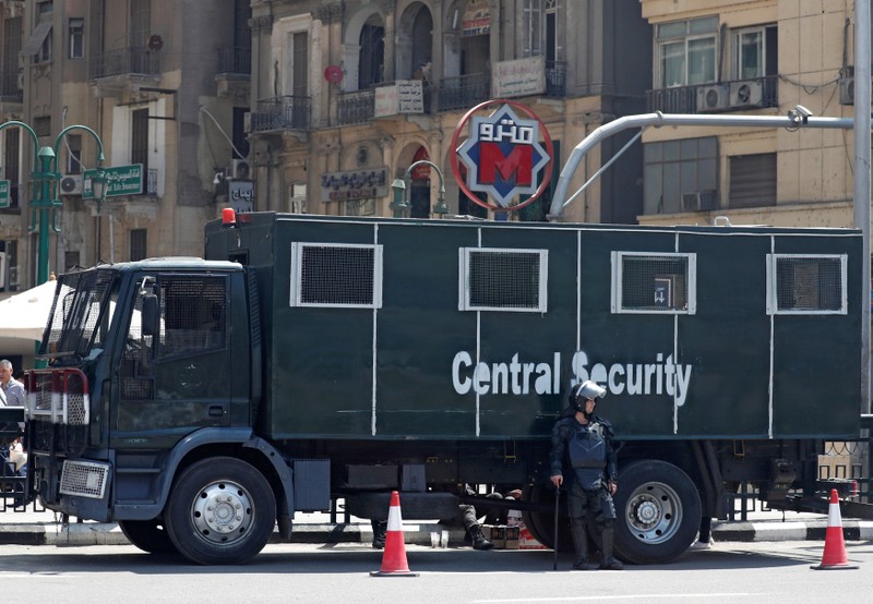 An Egyptian riot police officer is seen outside El Sadat metro station at Tahrir square in the center of Cairo