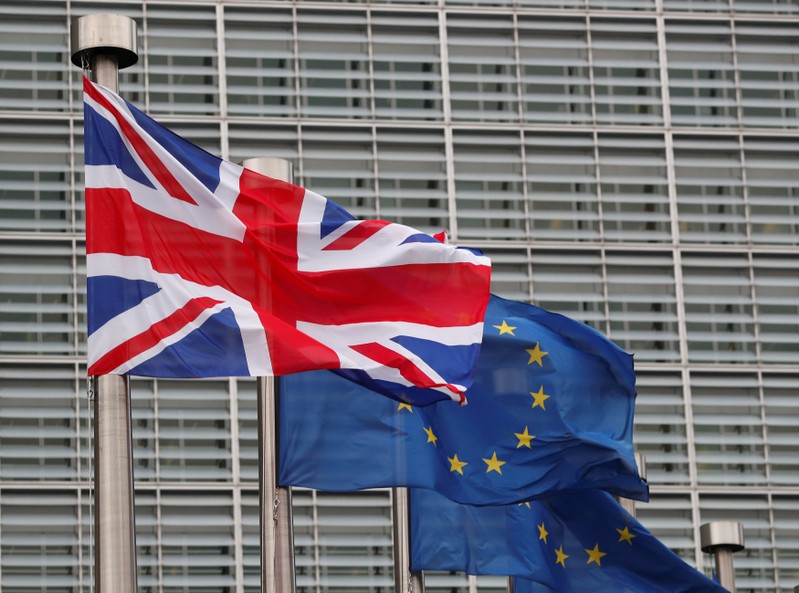 FILE PHOTO: A Britain's and some European flags are hung outside the EU Commission headquarters in Brussels