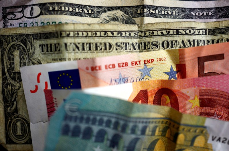FILE PHOTO: U.S. dollar and Euro bank notes are photographed in Frankfurt, Germany, in this illustration picture