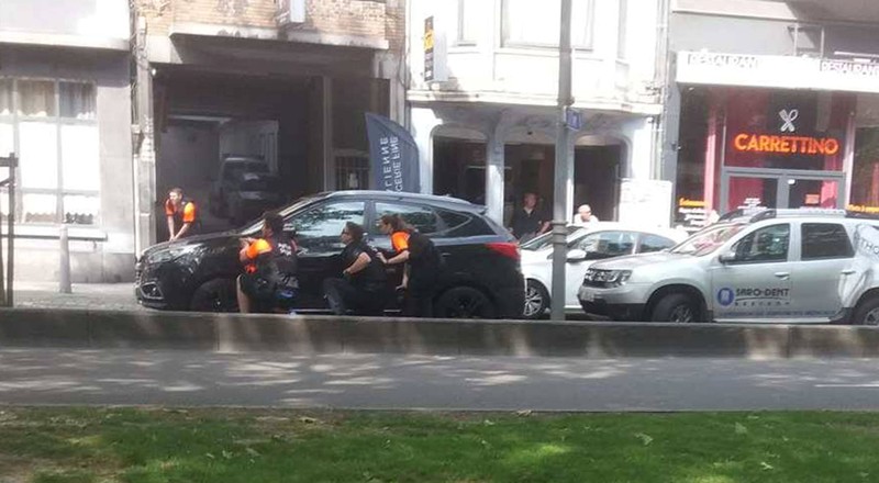 Police officers are seen on the scene of a shooting in Liege