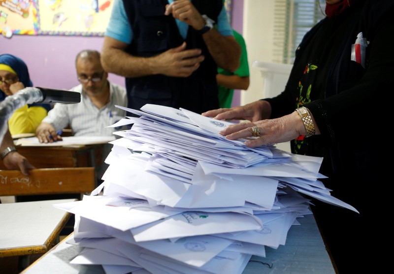 Lebanese election officials count ballots after the polling station closed during Lebanon's parliamentary election, in Beirut