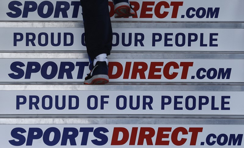 A worker walks up stairs before a Sports Direct general meeting to vote on the re-appointment of chairman Keith Hellawell in Shirebrook