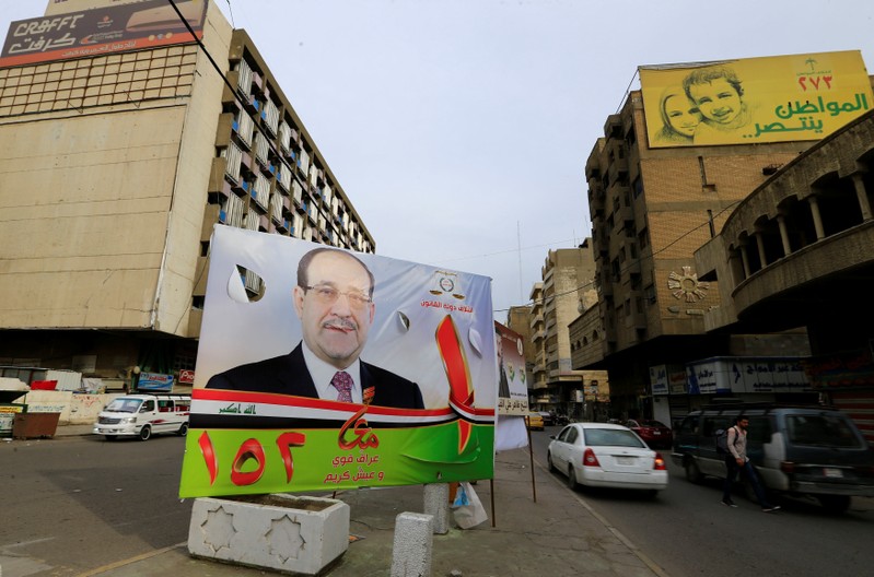 A campaign poster of former Iraqi Prime Minister Nuri al-Maliki is seen in the street ahead of the parliamentary election, in Baghdad