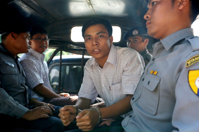 FILE PHOTO: Detained Reuters journalist Kyaw Soe Oo and Wa Lone are transport in a police vehicle after a court hearing in Yangon