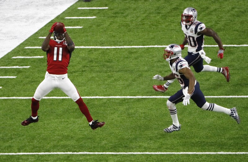 Atlanta Falcons' Jones makes a catch for a gain of 19 yards as New England Patriots' Ryan and Harmon look on during the second quarter at Super Bowl LI in Houston