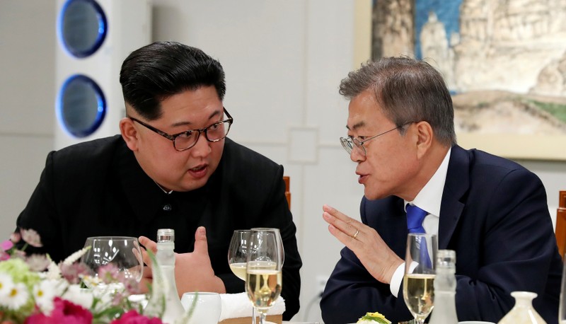 FILE PHOTO - South Korean President Moon Jae-in and North Korean leader Kim Jong Un attend a banquet on the Peace House at the truce village of Panmunjom