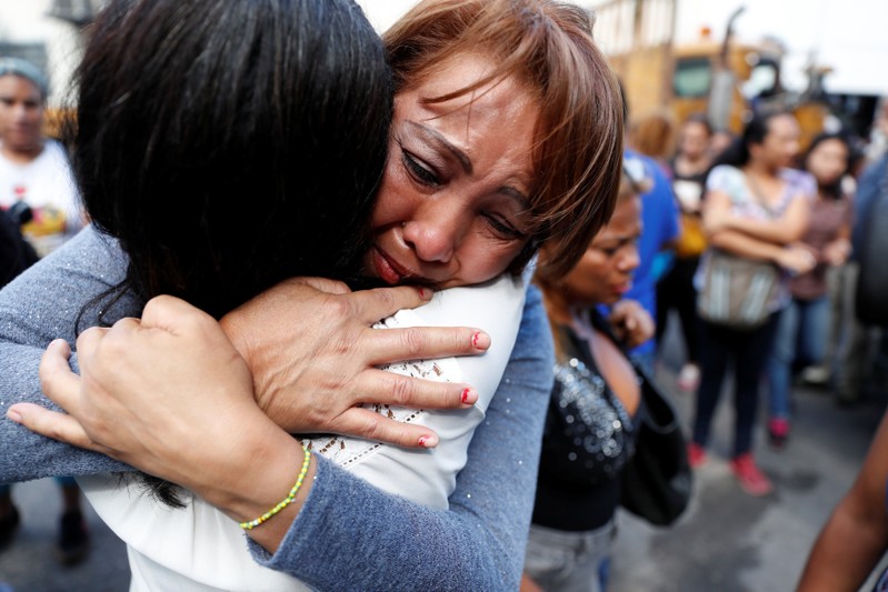 Relatives of inmates react outside a detention center of the Bolivarian National Intelligence Service (SEBIN), where a riot occurred, according to relatives, in Caracas