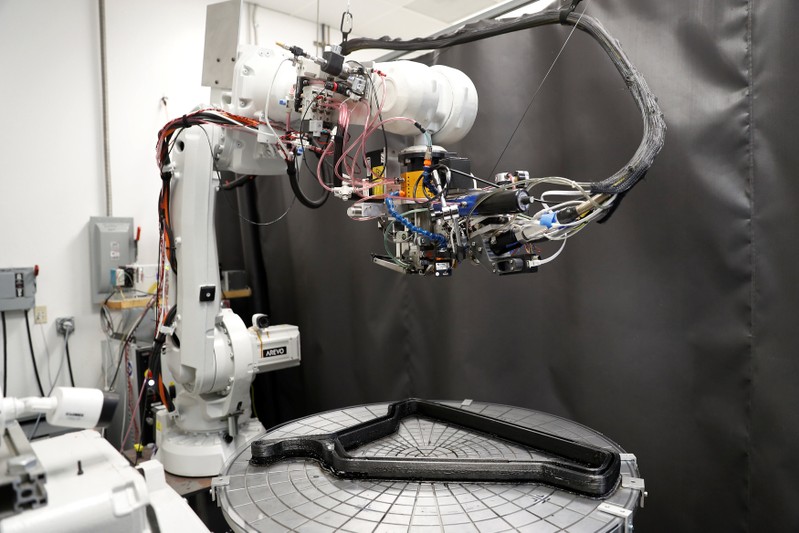 A 3D-printing robot is seen printing a carbon fiber bicycle frame at Arevo Labs in Santa Clara, California