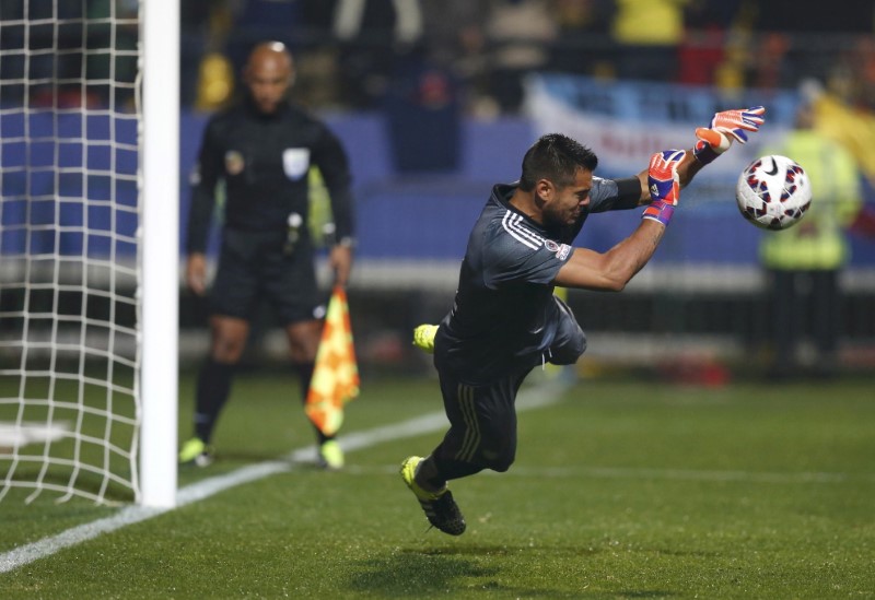 FILE PHOTO: Argentina's goalie Romero stops a shot by Colombia's Zuniga during penalty kicks following the end of regulation play in their Copa America 2015 quarter-finals soccer match at Estadio Sausalito in Vina del Mar