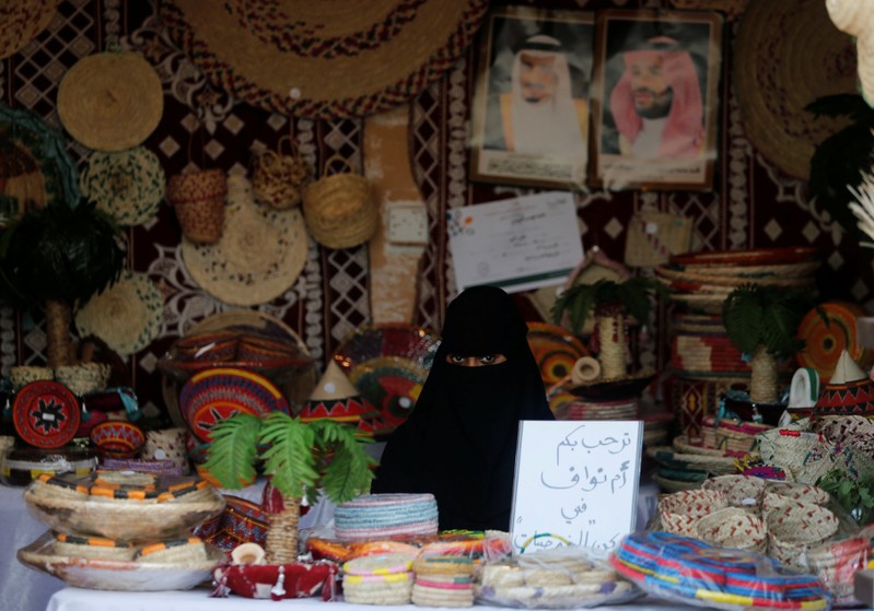FILE PHOTO - A Saudi woman sits in her shop at heritage village during Gulf Coastal Cultural Festival at Dammam Corniche, Dammam