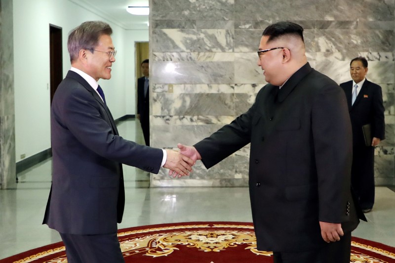 FILE PHOTO: South Korean President Moon Jae-in is greeted by North Korean leader Kim Jong Un during their summit at the truce village of Panmunjom