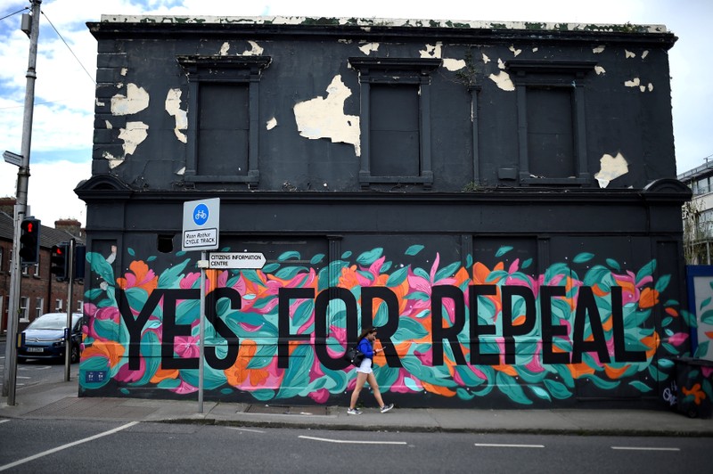 FILE PHOTO: A woman walks past a Pro-Choice mural on the side of a building ahead of a 25th May referendum on abortion law