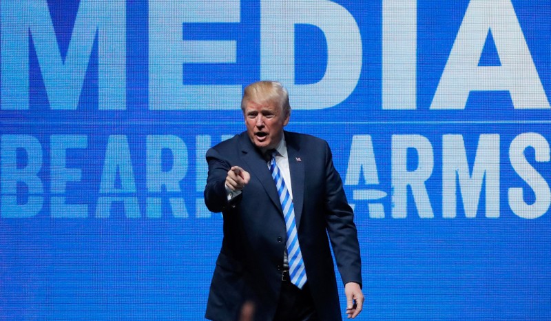 FILE PHOTO: U.S. President Donald Trump gestures after speaking at a National Rifle Association (NRA) convention in Dallas