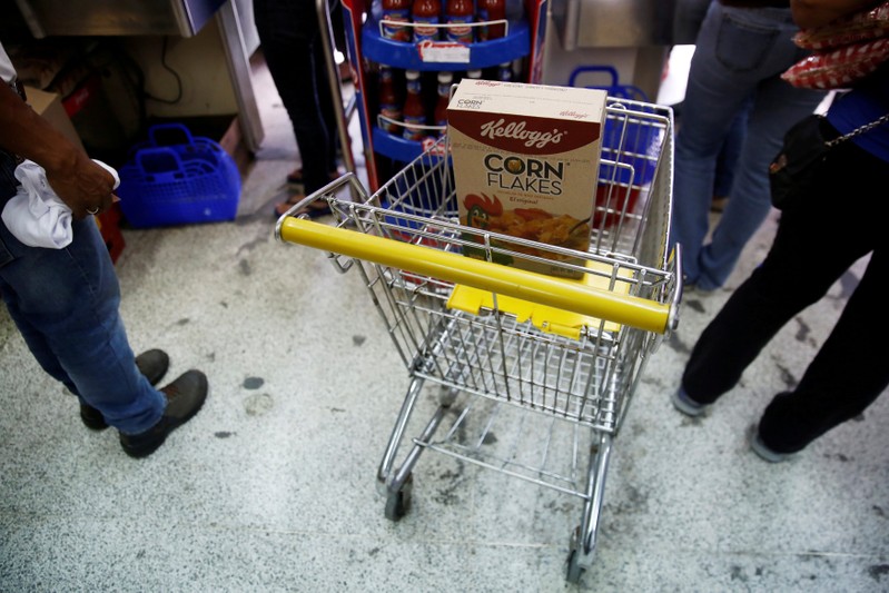 A box of corn flakes made by Kellogg is seen on a shopping cart inside a local shop in Caracas