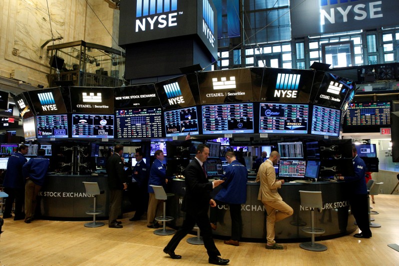 FILE PHOTO: Traders work at the Citadel Securities post on the floor of the NYSE