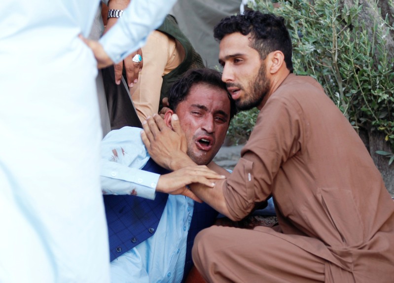 An Afghan man mourns in a hospital after a car bomb, in Jalalabad city
