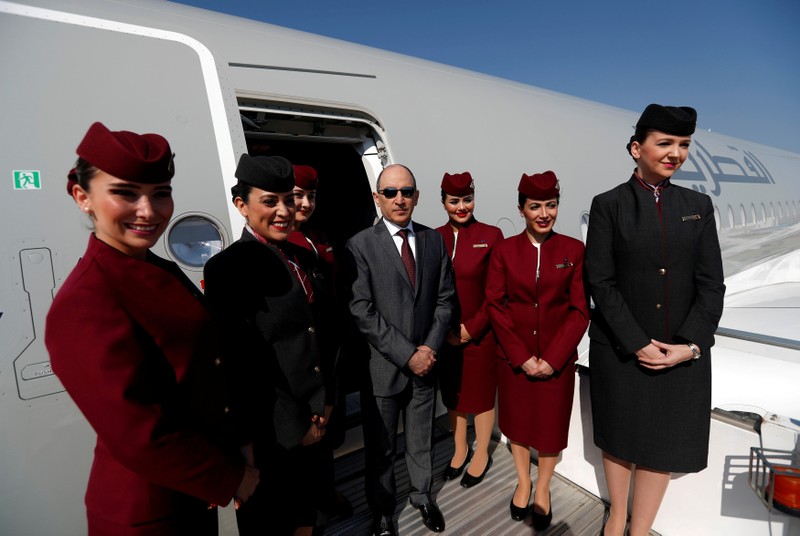 FILE PHOTO: Qatar Airways Chief Executive Officer Akbar al-Baker poses with cabin crew in an Airbus A350-1000 at the Eurasia Airshow in the Mediterranean resort city of Antalya